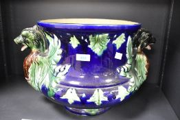 A large decorative majolica style jardiniere, of urn form in green bown and cobalt glaze with