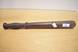 A Victorian turned wooden police truncheon, thought to be used by a Constable, featuring a