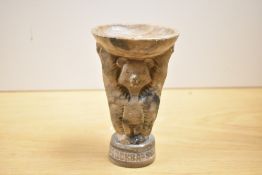 An unusual 1980 Moscow Olympics carved stone souvenir, formed as Misha Bear holding a bowl, the base