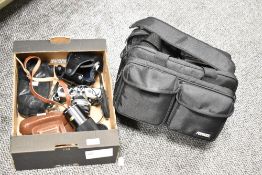 A vintage Olympus OM-1 35mm SLR film camera with a 50mm f/1.8 F.Zuiko Auto-S lens; sold with a Zeiss