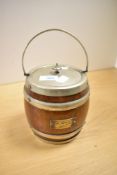 An early 20th-century oak biscuit barrel, silver-plated banded and fitted with a lidded top with
