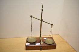 A Victorian Goodbrand and Holland of Manchester apothecary brass balance scale on a wooden base;