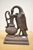 A late 19th-century cast iron 'Ho-Ho' bird door porter, featuring the feathered bird drinking from a