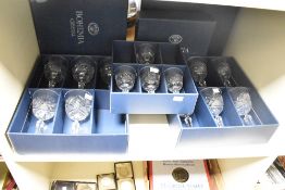 A quantity of 20th-century Bohemia Crystal wine goblets, featuring a star burst design to the bowl