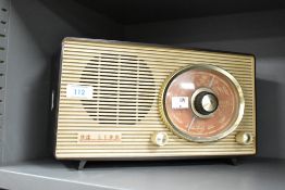 A mid 20th-century Philips 2G04U valve bakelite radio, having a tube/valve that operates on MV and