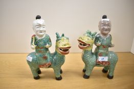 A pair of Chinese export famille verte figures of boys riding Qilin, 25cm one Qilin with depletion