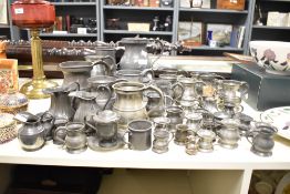 A large quantity of 19th to early 20th-century pewter tankards and ewers, to include a large