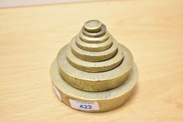 A set of eight cast brass graduating/nesting weights, 1/2 Oz - 4lb, one weight (1oz) possibly