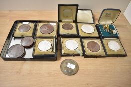 A quantity of Victorian University of Cambridge sporting prize medals, encased within glass, to