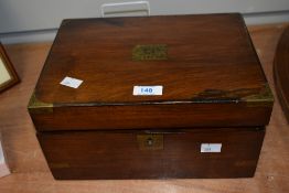 A late 19th-century mahogany writing slope with brass mounted corners, having inside compartments,
