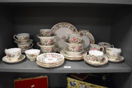 A 20th-century Crown Staffordshire bone china part tea set, featuring a delicate pink and purple