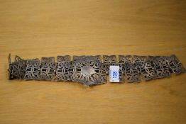 A silver plated nurses belt, the large central buckle of a pierced scroll design flanked by
