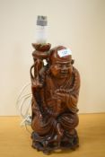 A 20th-century Chinese carved hardwood 'Laughing Buddha' lamp base, approximately 38cm, condition is