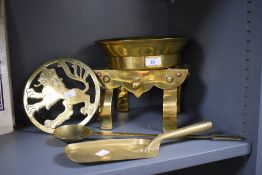 A selection of early 20th-century brassware, to include a Rampant Lion motif trivet; a decorative