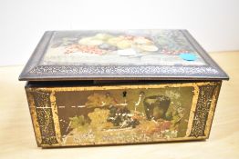 A early 20th-century decorative hinged casket tin jewellery box, featuring a fruit still-life design