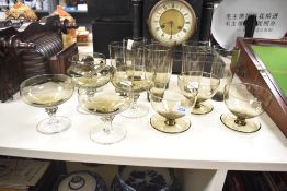 A selection of 20th-century 'smokey' studio art glass, featuring five twisted base coupes; three