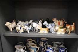 A large quantity of 20th-century ceramic cow creamers/milk jugs, to include one small and three
