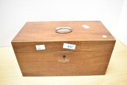 A 19th century mahogany tea caddy, of hinged rectangular form with central associated glass bowl