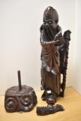 A large Carved Chinese hardwood immortal Shou Hsing, modelled holding a staff and looking to one