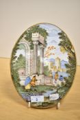 A mid 18th-century majolica style oval plaque, possibly Castelli by Nicola Cappelletti,depicting a