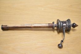 A modern decorative Tibetan prayer wheel, the revolving head with symbols and repeating borders