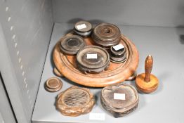 A quantity of 20th-century Oriental-style carved hardwood display stands, used for elevating various