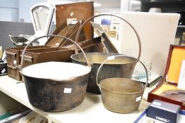 Three late 19th to early 20th-century brass and iron jam pans/cooking pots, featuring fixed loop
