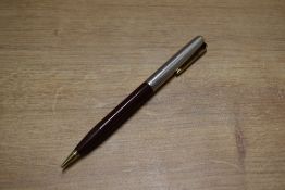 A Parker 51 vacumatic rotary pencil in Cordovan Brown with lustraloy wedding band cap and gold trim.