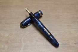 A Conway Stewart 84 lever fill fountain pen in Blue Marble with gold veins with single broad cap