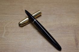 A Parker 51 aerometric fill fountain pen in Black with Gold Fill converging line cap. Circa 1950