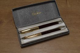 A boxed Parker 51 aerometric fill fountain pen and ballpoint pencil in Burgundy with Rolled Gold