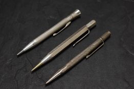 Three Hallmarked Silver pencils. A round engine turned Eversharp, London 1951, a hexagonal engine