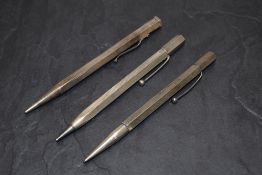 Three hexagonal pencils one Sterling Silver and two Hallmarked Silver. A Yard O Led of smooth form