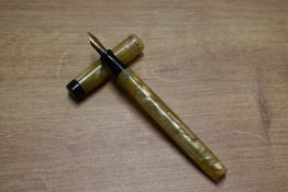 A Valentine Junior lever fill fountain pen in Green and Gold Marble with single cap band having a