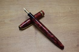 A Conway Stewart 85L lever fill fountain pen in Red Marble with gold veining with single wide cap