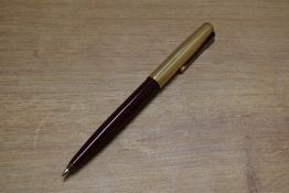 A Parker 51 ballpoint pen in Burgundy with Rolled Gold converging lines cap. Circa 1955