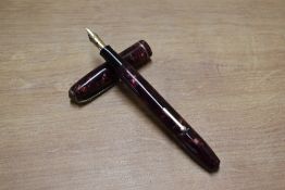 A Conway Stewart 75 lever fill fountain pen in Red Marble with single cap band having Conway Stewart