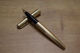 A boxed Parker 65 Insignia cartridge/ converter fill fountain pen in Rolled Gold