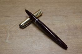 A Parker 51 vacumatic fill fountain pen in Cordovan Brown with Gold fill converging line cap.