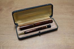 A boxed Majestic Baby lever fill fountain pen and pencil in Red Ripple hard rubber with single