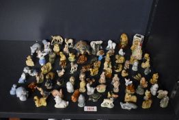 A large assortment of English Pottery Wade 'Whimsies' to include monkey, tiger, dolphin, elephant,