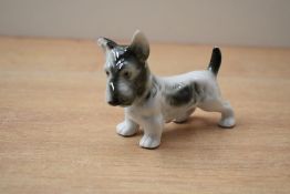 A Royal Dux bone china terrier study, bearing stamp '151 and 74' to underside with pink triangle,