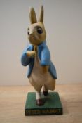 A rare 1950's cast composite Peter Rabbit shop display advertising figure, mounted on square base,