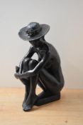 A large heavy resin figurine, depicting a seated female with large sun hat, measures 37cm tall.