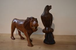 Two wooden animal studies, lion and eagle, both cracked in areas, measuring 20cm and 28cm tall.