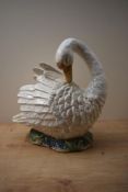 A large 20th century ceramic swan study depicted on a bed of grass, stamped '38' to underneath,