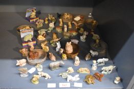 A large assortment of English Pottery Wade 'Whimsies' to include lion, rhinoceros, butterfly,