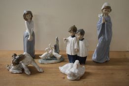 Six Lladro and Nao by Lladro porcelain figures and studies including 'Playful Puppy' and 'Girl
