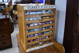 A vintage cotton reel display for Clark's Anchor , having seven divided drawers with glass fronts,
