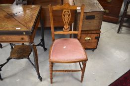 A Victorian bedroom chair having overstuffed seat and turned frame